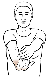 Woman doing wrist extension exercise.