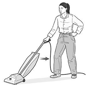 Woman pulling vacuum cleaner towards herself.