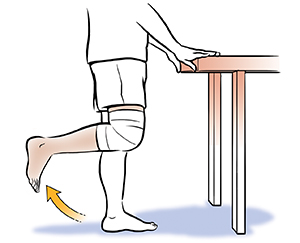 Persona vista de la cintura para abajo haciendo flexiones de rodilla, de pie.