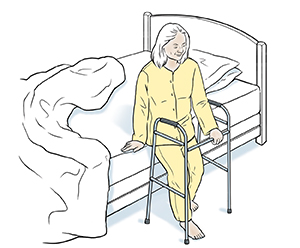 Una mujer sentándose en el borde de la cama con un andador.